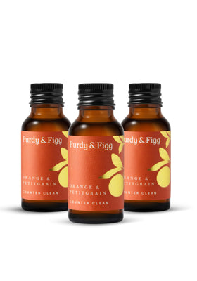 3 small orange with gold leaf concentrate bottles