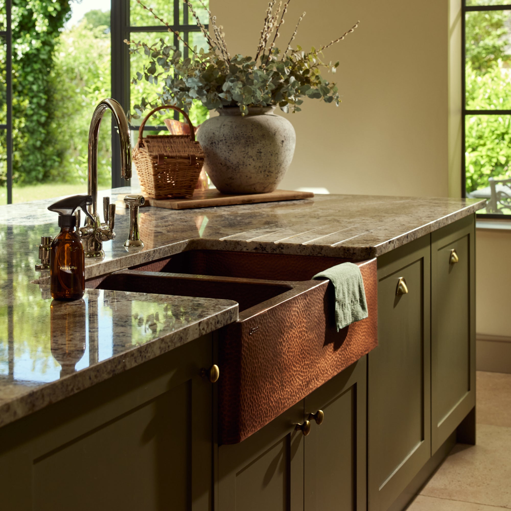 Granite sink top with Bottle for Life, glass doors open to beautiful garden